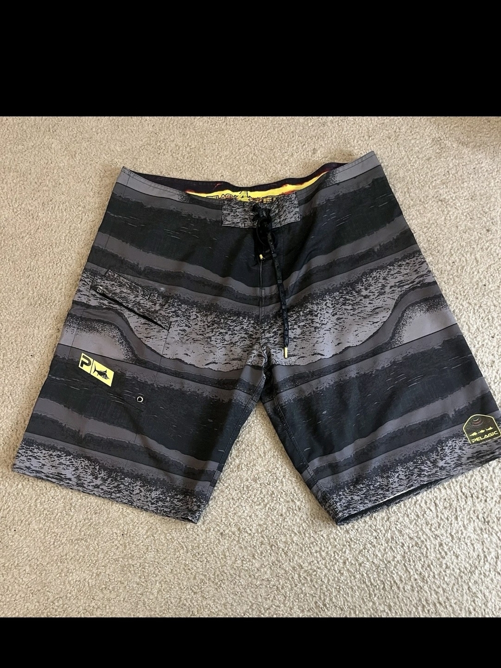 Pelagic Black and Gray Striped Board Shorts with Yellow Accents